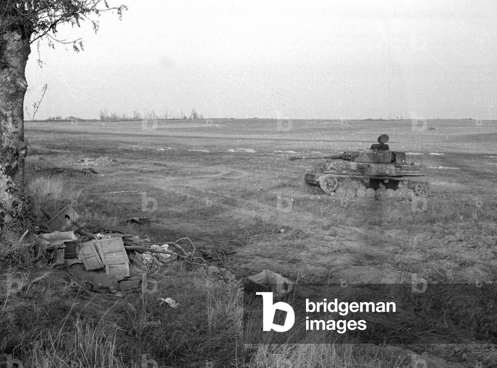 Destroyed German Mk IV Special. The ridge with the wood on the sky-line being the much attacked point 112, south of Caen, 1944 (b/w photo)