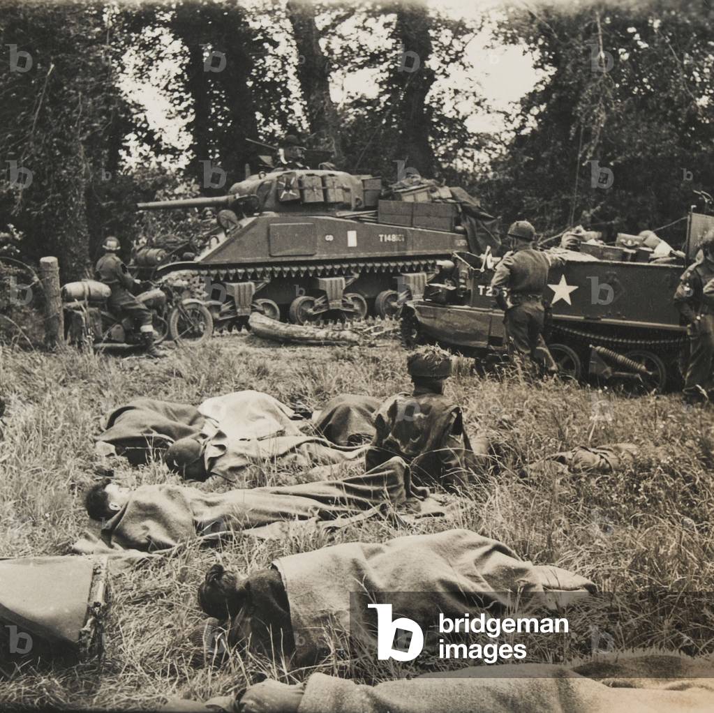 British tank crews rest while awaiting the order to advance inland, Normandy, June 1944 (b/w photo)
