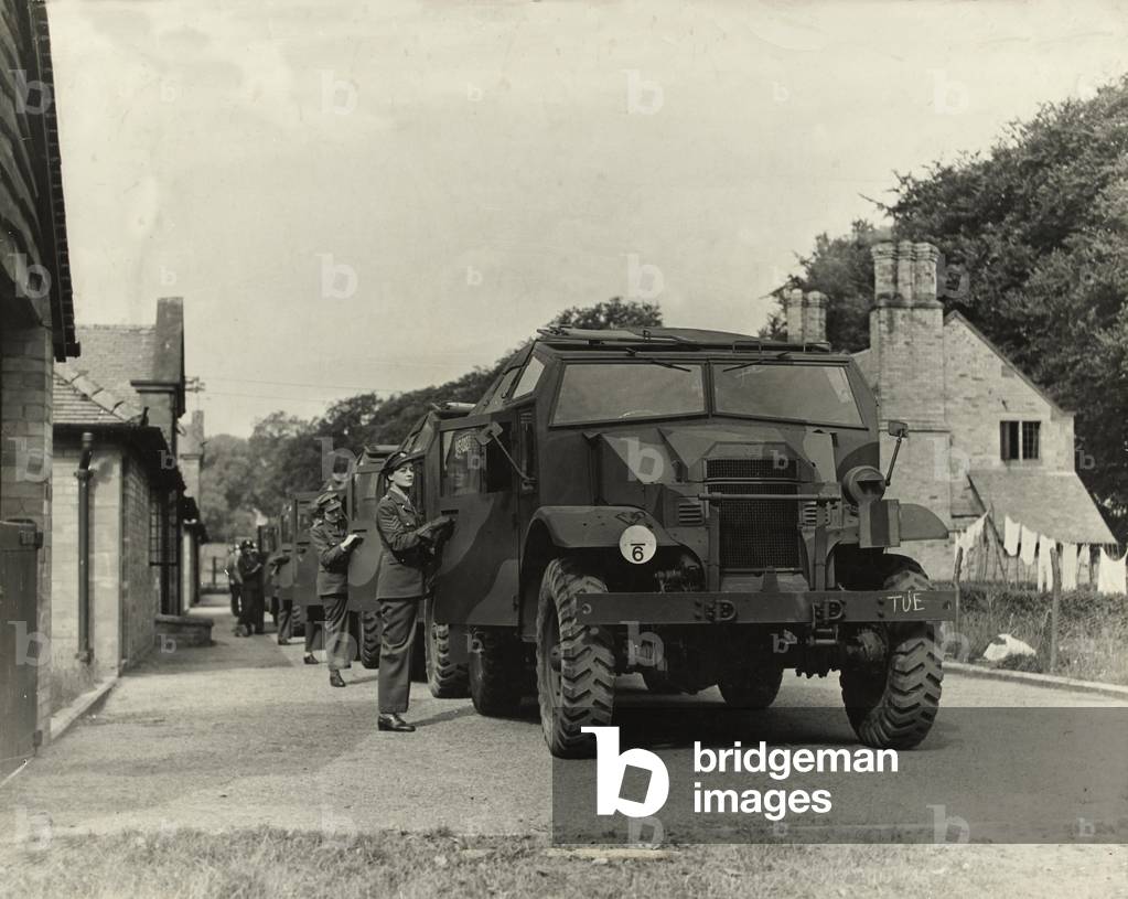 Quad tractors with women drivers posing by cabs, 1939-45 (b/w photo)