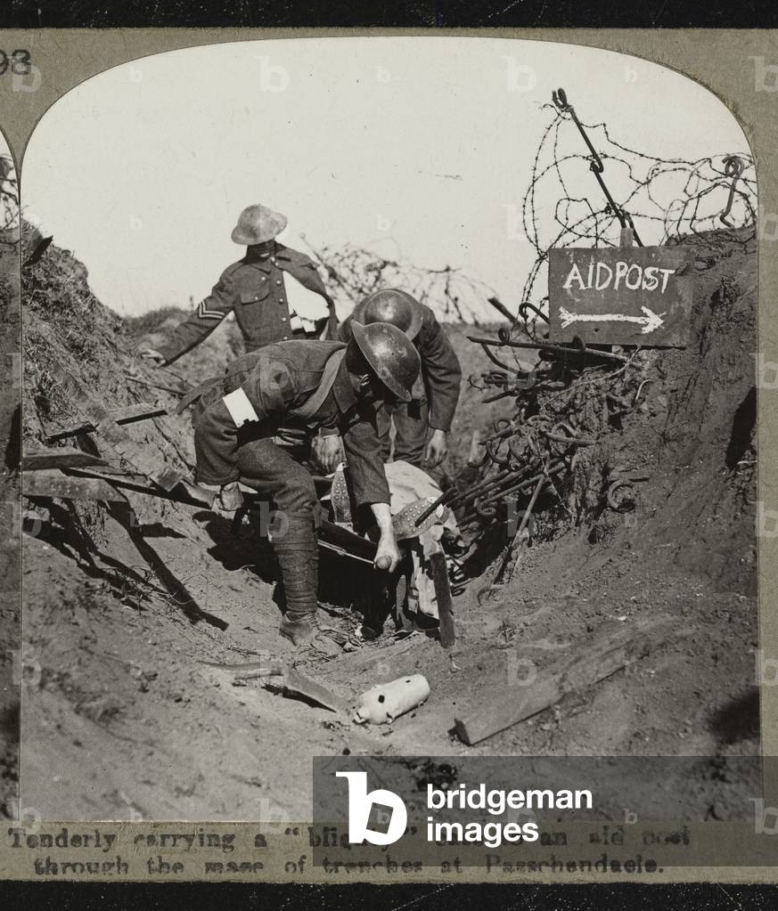 Stereoscopic photograph: 'Tenderly carrying a 'blighty' case to an aid post through the mass of trenches at Passchendaele', 1917 (b/w photo)