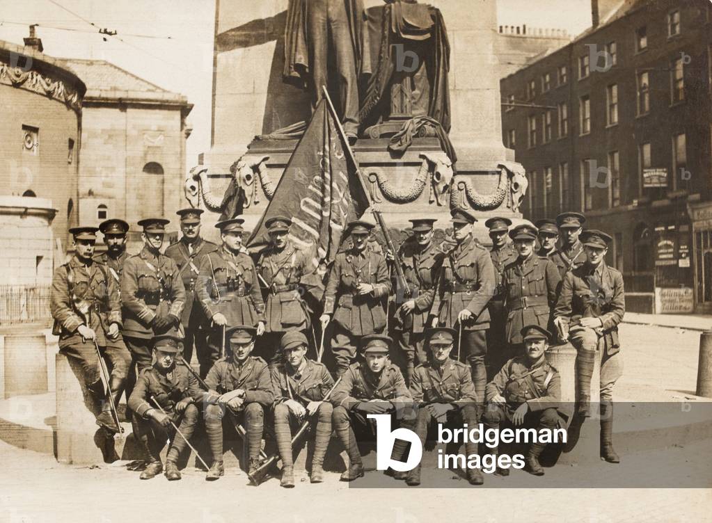 Officers of 3rd Battalion The Royal Irish Regiment with a captured Sinn Fein flag, Easter 1916 (b/w photo)