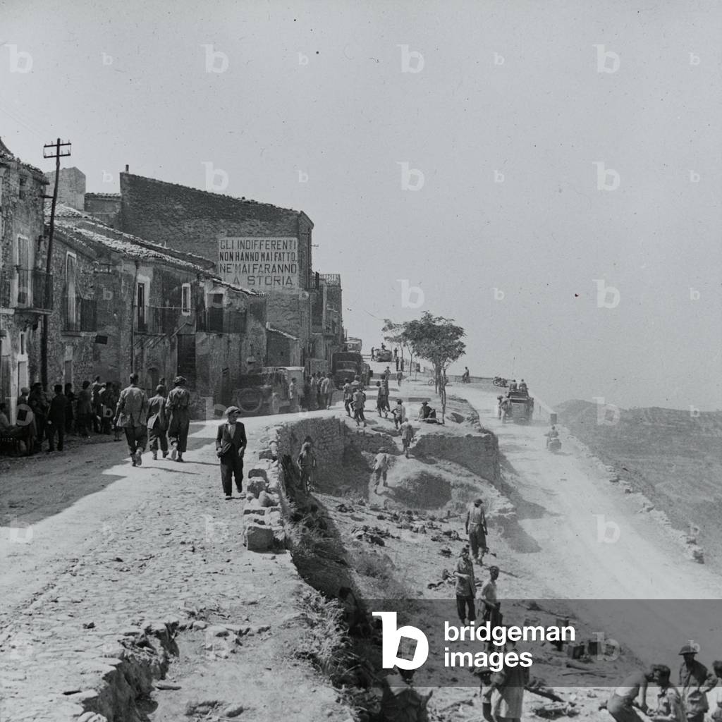 Troops and vehicles entering Centuripe after its fall to the 78th Division, 1943 (lantern slide)