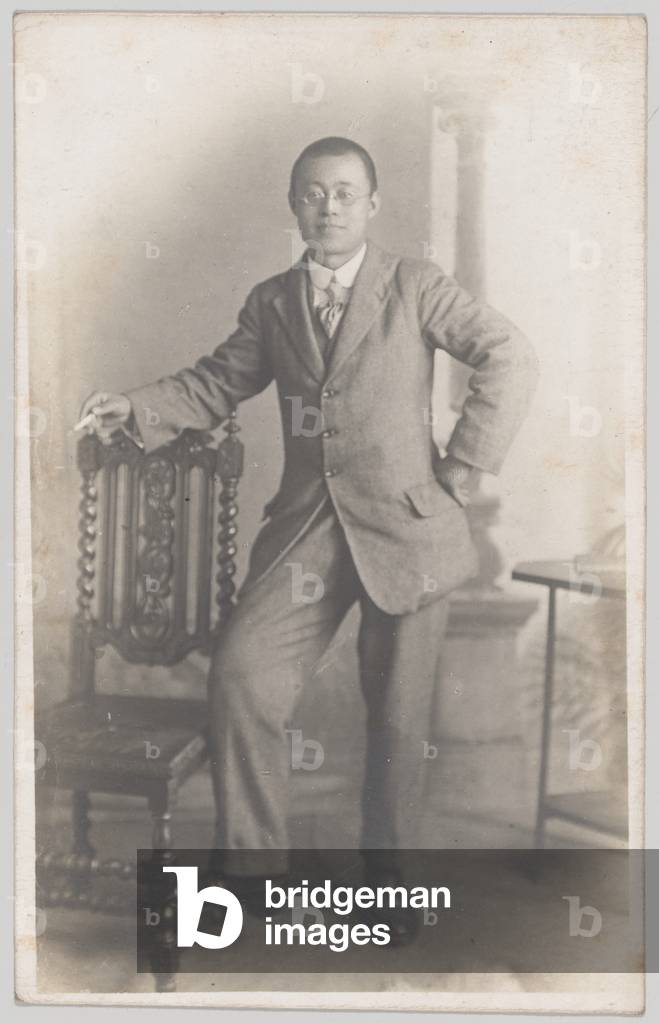 Studio portrait of a Chinese man in civilian dress, possibly a translator for 55th Company, Chinese Labour Corps, 1919 circa (b/w photo)
