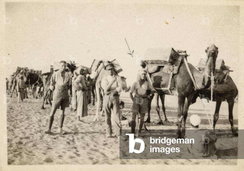 Joseph Egerton and British soldiers  carrying water for troops in the desert, Palestine, 1917 (b/w photo)