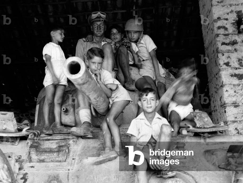 Lieutenant Sale with refugee children at Nicolosi, Sicily, 1943 (b/w photo)