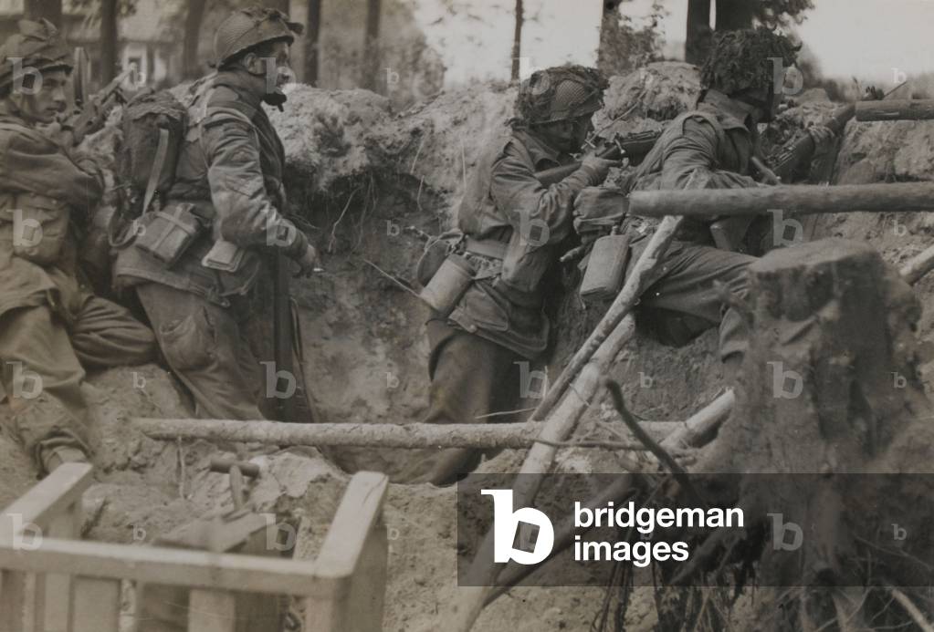 Members of 1st Airborne Division take cover in a shell hole, Arnhem, 17 September 1944 (b/w photo)