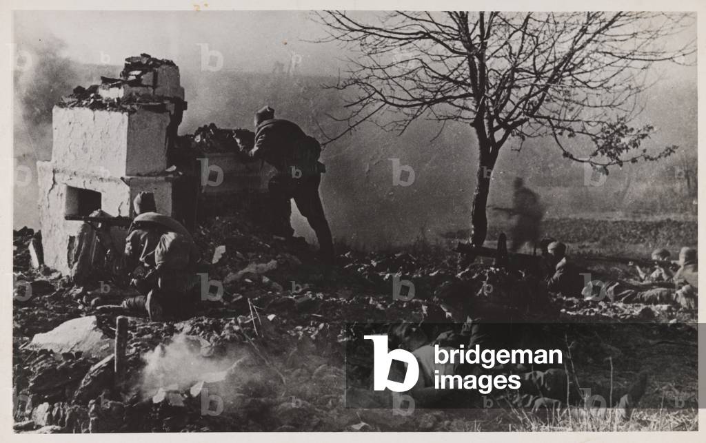 Red Army soldiers taking advantage of cover during their advance on a railway station in the Kuban Valley, 1943 (b/w photo)