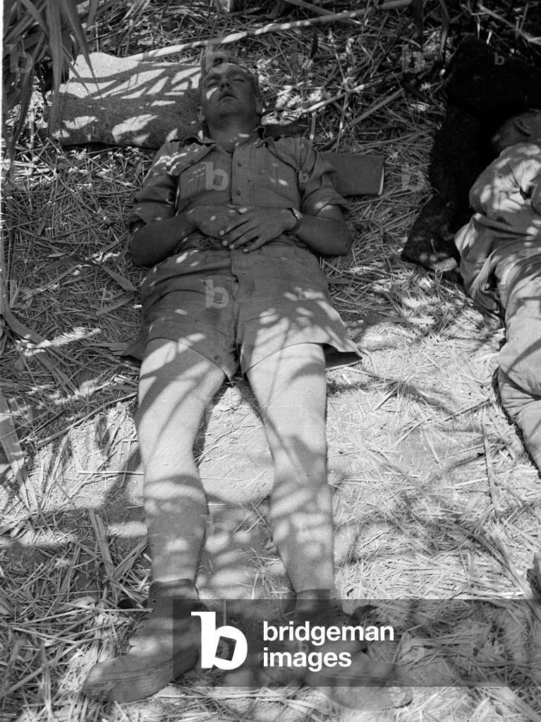 Rude pallet, a member of 3rd County of London Yeomanry (Sharpshooters) sleeping near the River Simeto, Sicily, 1943 (b/w photo)
