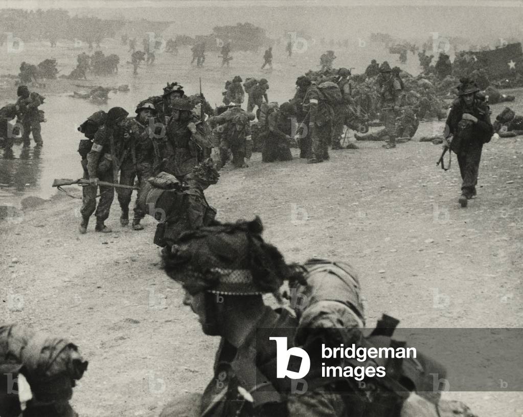 Soldiers wading ashore from landing craft at Ouistreham or Bernieres, St Aubin sector, 6th June 1944 (b/w photo)