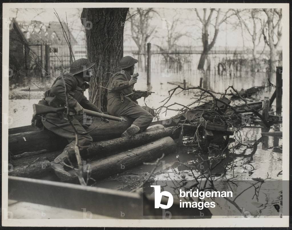 Photograph of Sgt R Raitley and Pte G B Ball among the floods south of Arnhem at Elst, 1944-45 (b/w photo)