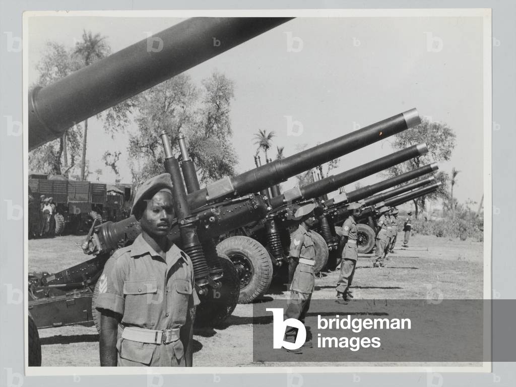 Gunners from 1st Medium Regiment, Indian Artillery, next to their guns, February 1946 (b/w photo)