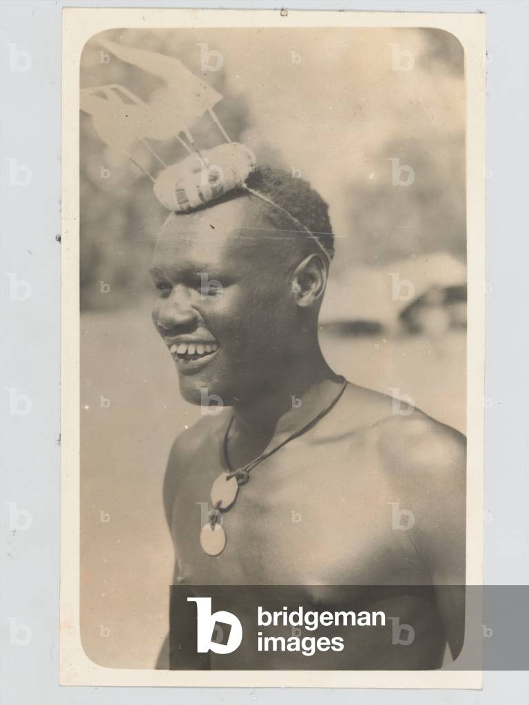 Askari with traditional headress and identity tags, 1942 (b/w photo)