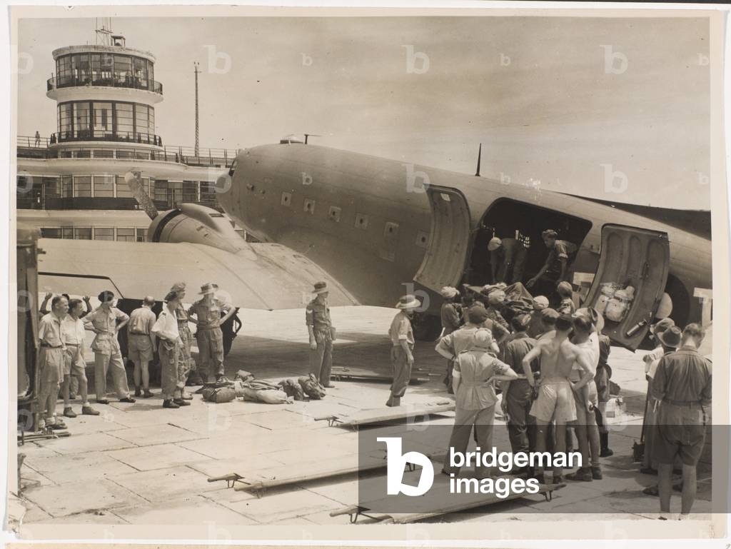 Prisoner of war stretcher cases arriving at Kallang airfield, Singapore, 1945 (b/w photo)