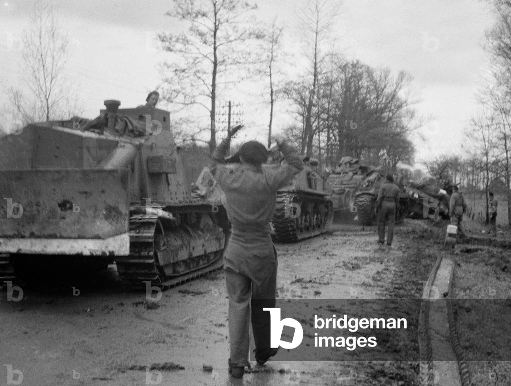 Fitters recovering tanks blown up on mines whilst moving at night near the level crossing of Ochtrup, 1945 (b/w photo)