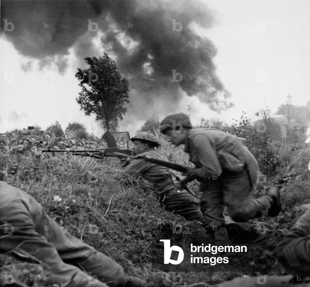Men of 2nd Derbyshire Yeomanry taking cover during the attack on St Michielsgestel, Antwerp, 25th October 1944 (b/w photo)