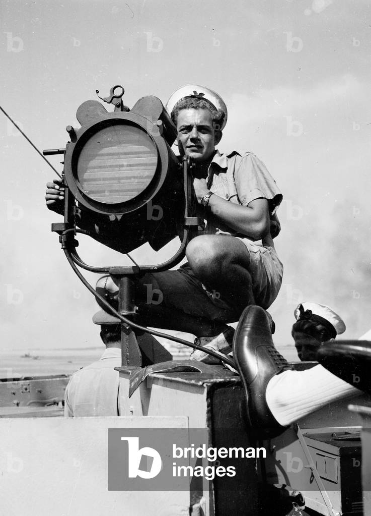 Sailor with Aldis signal lamp, 1943 (b/w photo)