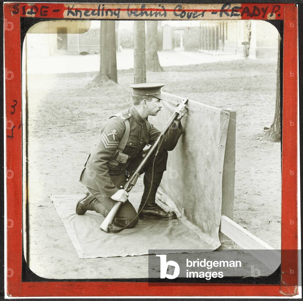 Kneeling Behind Cover, 1914 (lantern slide)