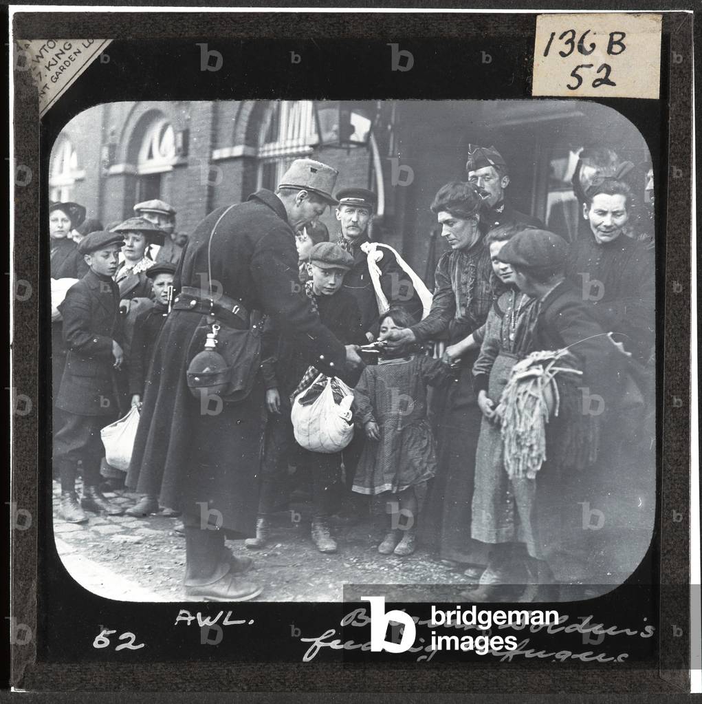 Belgian soldiers feeding refugees, 1914 (lantern slide)