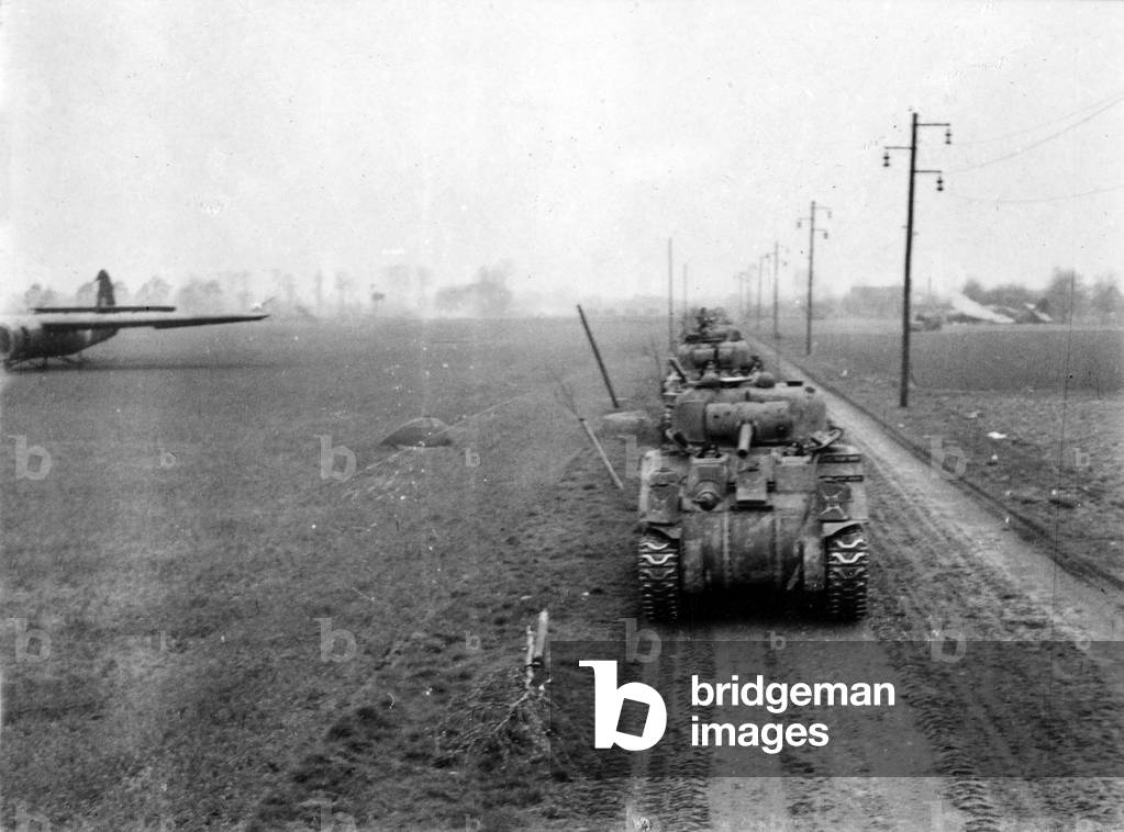 B Squadron Sherman tanks moving up through the the glider landing zone, Germany, 1945 (b/w photo)