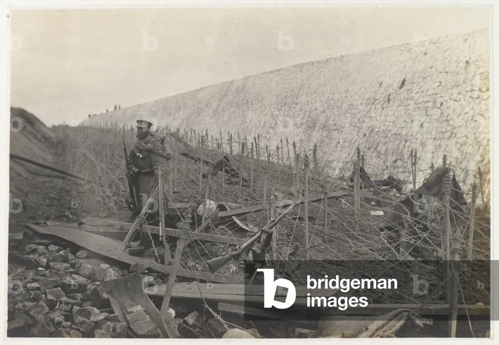 Japanese sentry among barbed wire entanglements, Tsingtao, November 1914 (b/w photo)
