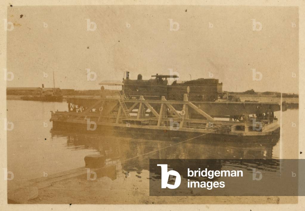 A ferry transporting a railway engine along the Suez Canal, Egypt, 1916 (b/w photo)
