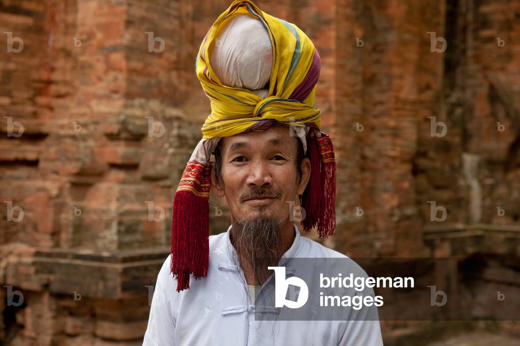 Man in traditional Champa dress at Po Nagar, a Cham temple tower founded around 781 AD and located near Nha Trang in Vietnam (photo)
