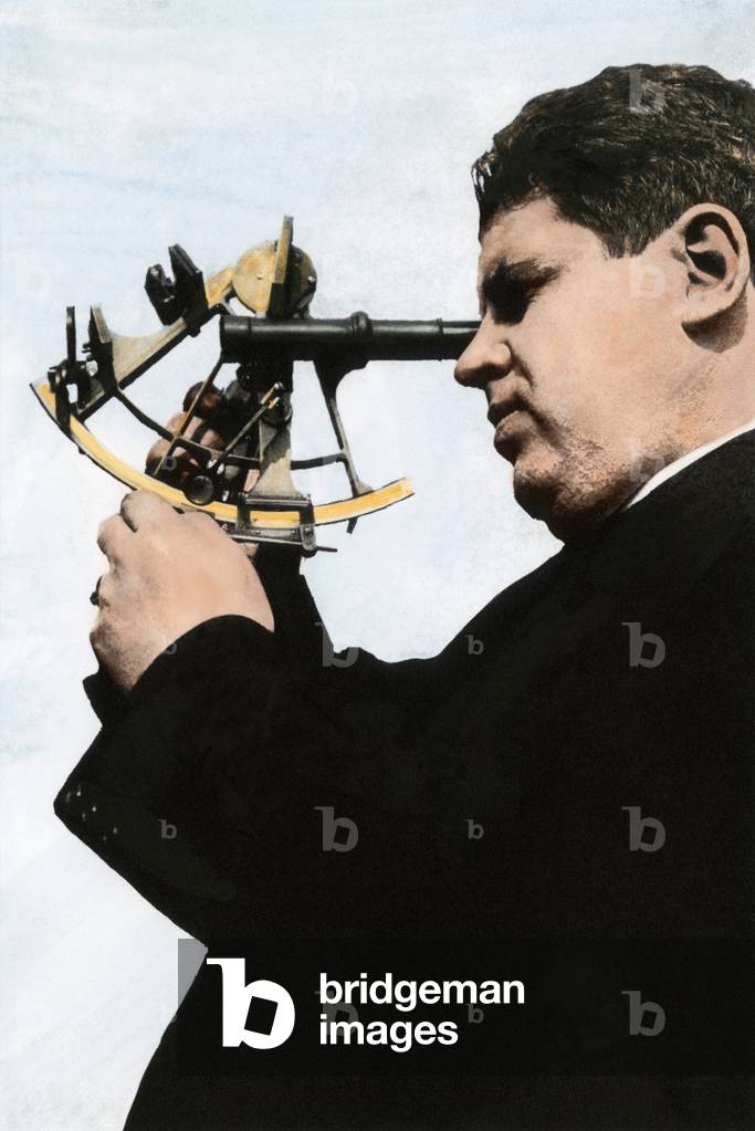 Navigation instrument: man using a sextant to measure his position. First 20th century. Colouring reproduction (Halftone) of a photograph.