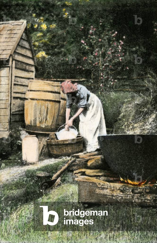 Daily life North America, domestic work: woman recuding soap, made from lard, boiled in a large outdoor tank