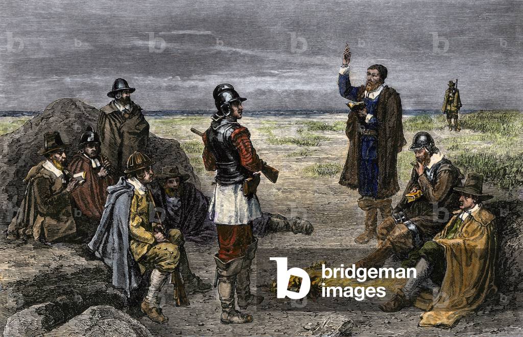 Mayflower pelerins observing the Sabbath rite (Sunday religious service) on Clark Island, Cape Cod, Massachusetts. Gather around a campfire, the men wrapped in their coats, listen to the preacher's speech. 17th century. 19th century lithography.