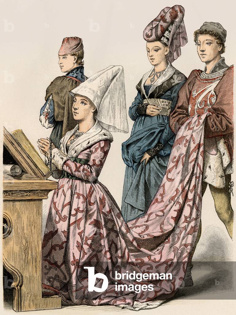A lady of the Burgundy nobility kneels in prayer, behind her, a lady of company and a page holding her dress. France 15th century. Old engraving, colour setting.