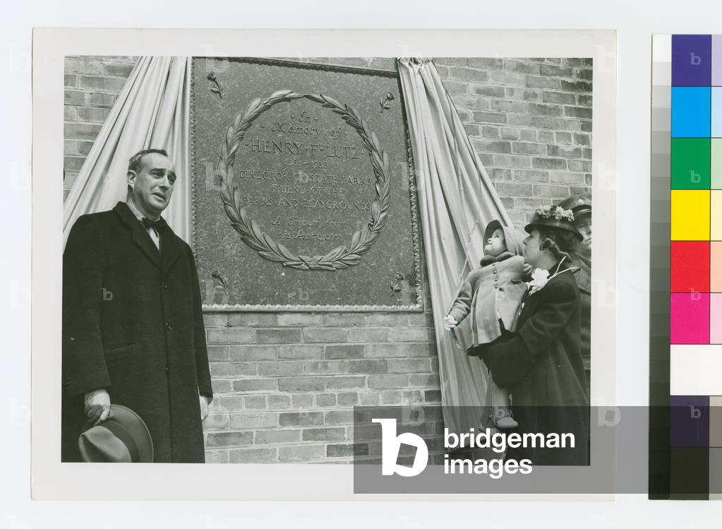 Robert Moses in front of a plaque dedicated to Henry Lutz, c.1935-45 (photo)