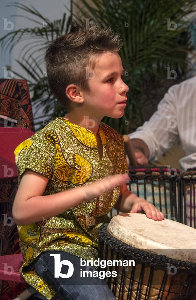 Young boy playing the djembe