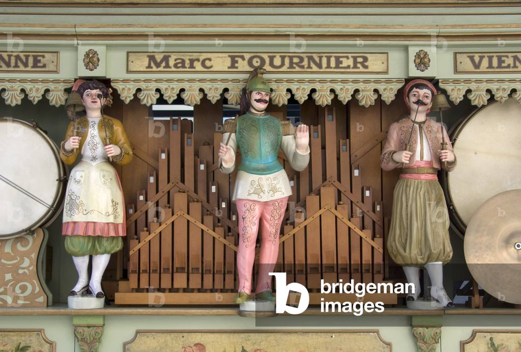Detail of colourful animated figures on a large barrel organ