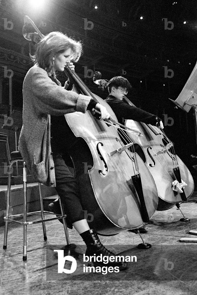 Two young double-bass players in rehearsal