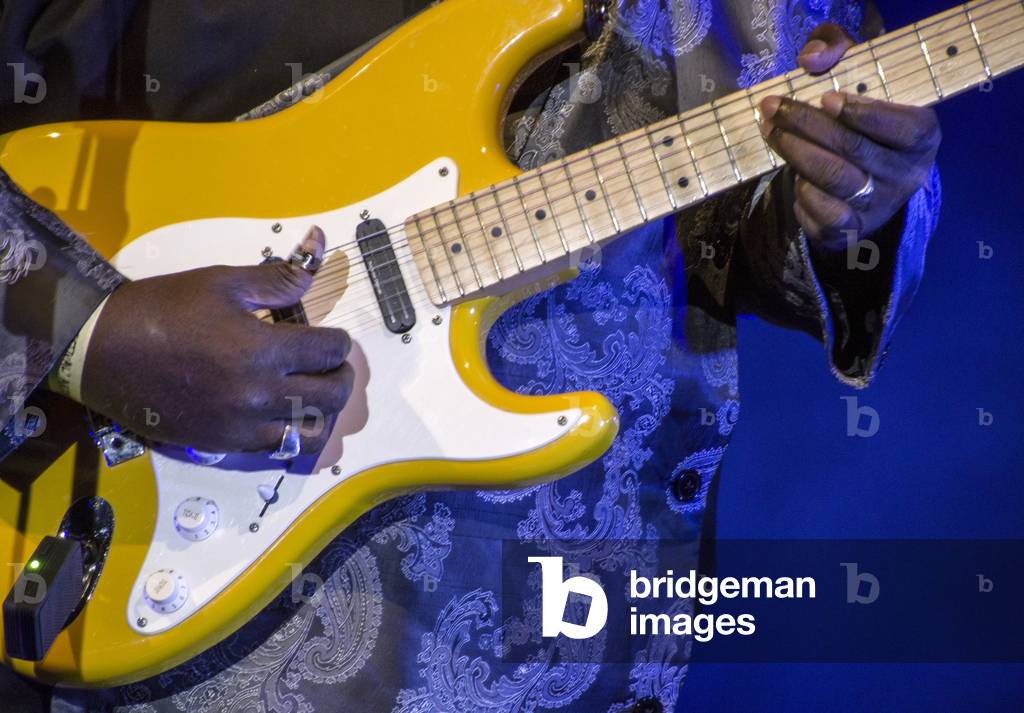Close-up of guitarist playing with a thumb pick, (photo)