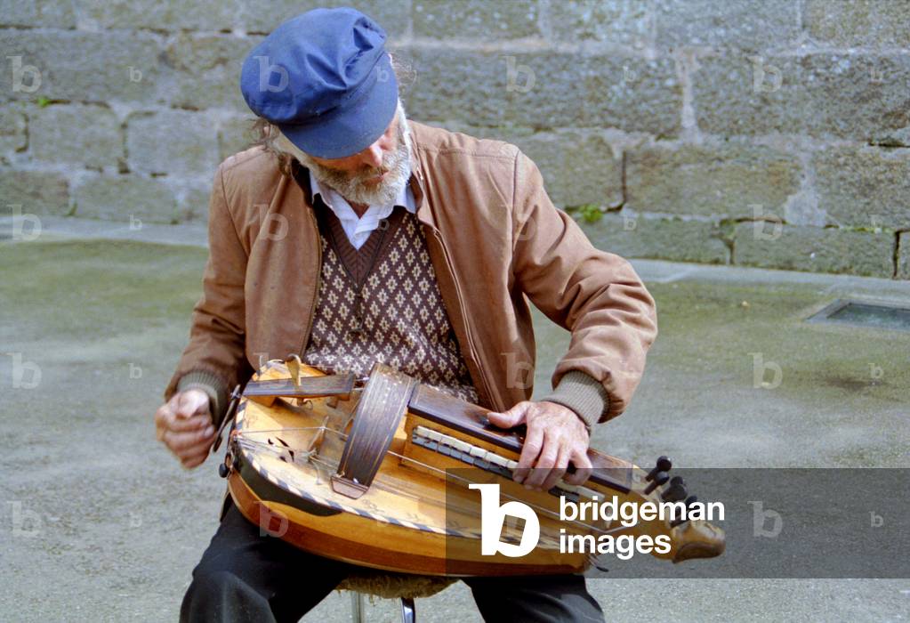 Busker playing a hurdy-gurdy.