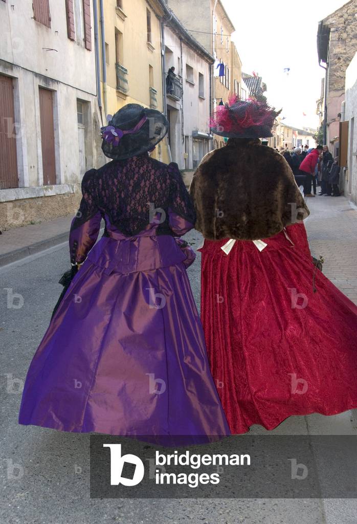 Two ladies in Victorian costumes (back view)
