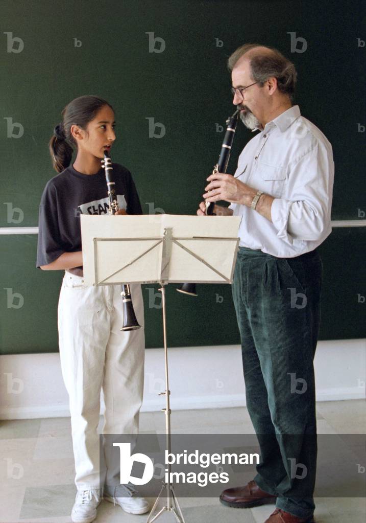 Male clarinet teacher with teenage female student.
