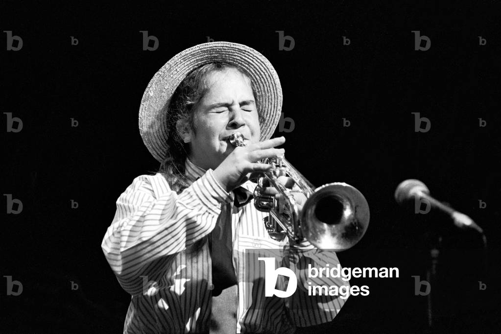 Teenage girl in school uniform playing the trumpet