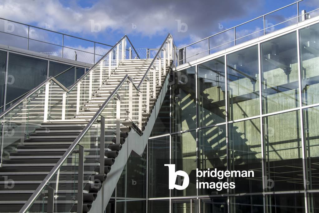 Exterior view of contemporary glass building with staircase, 2018 (photo).