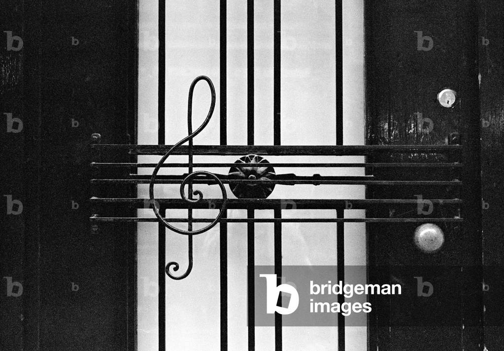 Front door decorated with wrought iron G-clef and stave