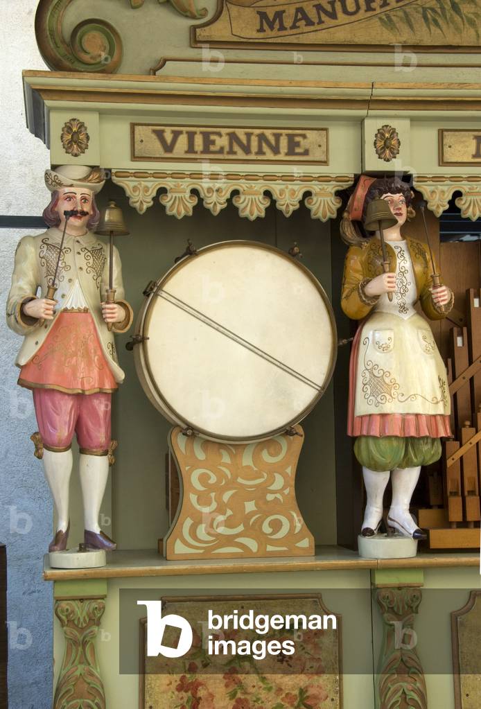 Detail of colourful animated figures on a large barrel organ