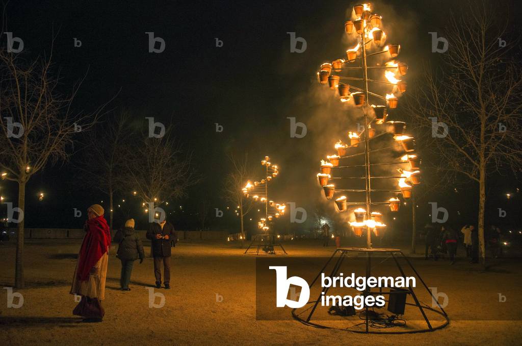 Metal structures bearing candles.