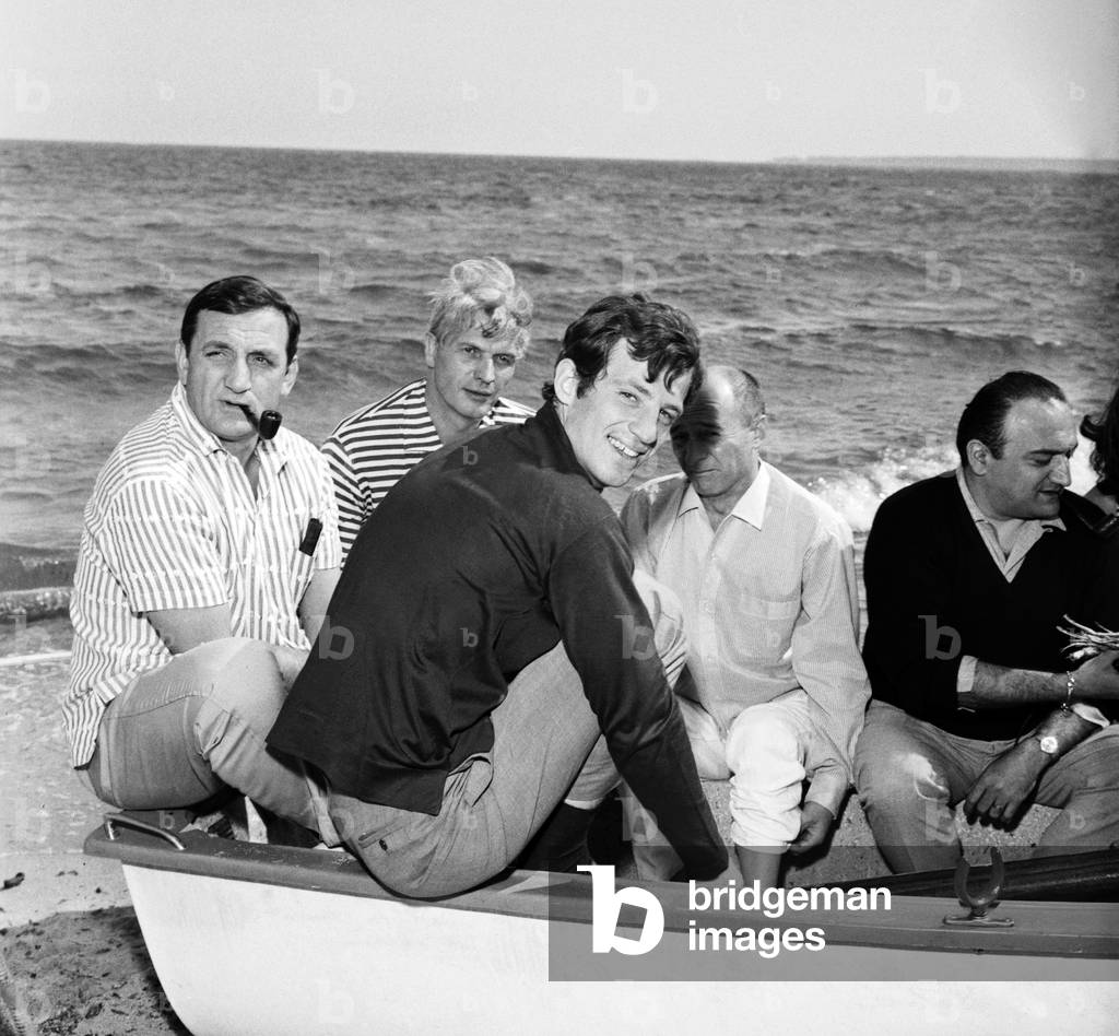 Lino Ventura, Jean-Paul Belmondo, Reginald Kernan and Henri Verneuil on a boat at the Cannes Festival, 1964 (b/w photo)