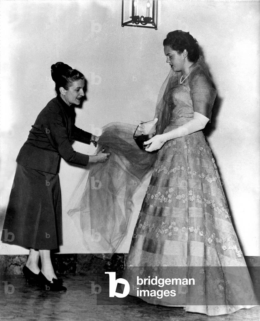 Princess Maria Pia di Savoia tries on a dress for her wedding to Prince Alexander of Yugoslavia, 1955 (b/w photo)