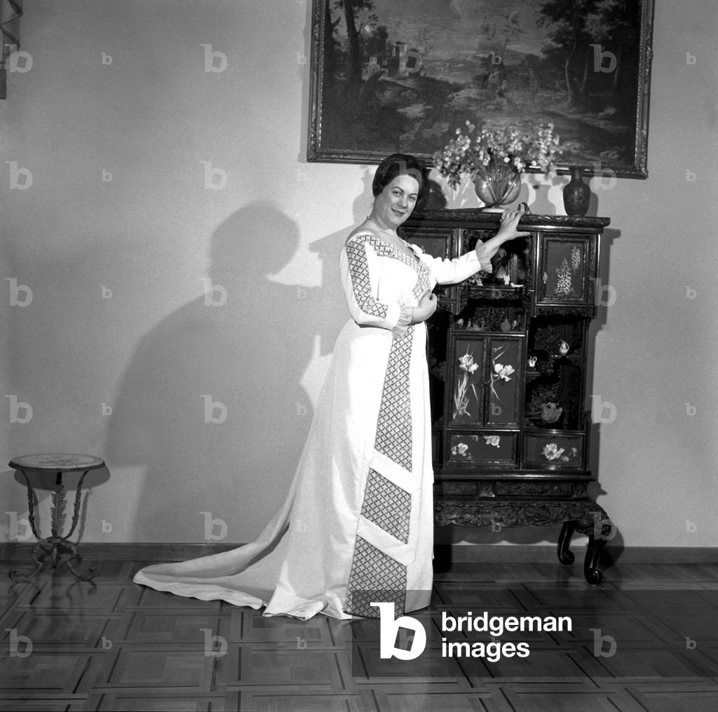 Renata Tebaldi at home trying on costumes for Umberto Giordano's opera 