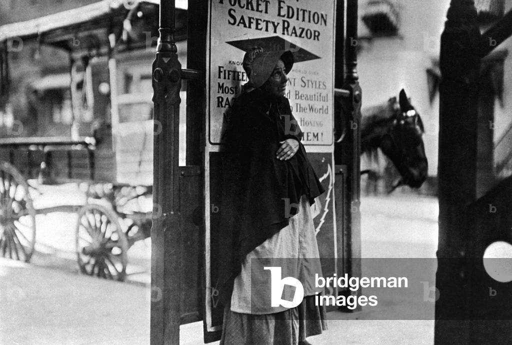 A beggar woman on the streets of New York, USA, 1910 (b/w photo)