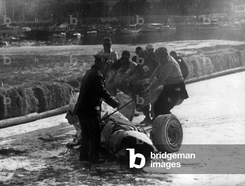 The Ferrari of Italian driver Lorenzo Bandini after his fatal accident at the Formula 1 Grand Prix, Montecarlo, Monaco, 1967 (b/w photo)