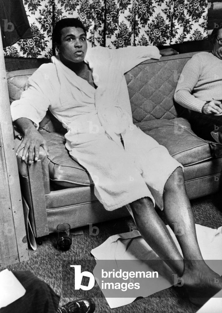 Muhammad Ali in his bathrobe after his meeting with Joe Frazier, USA, 1974 (b/w photo)