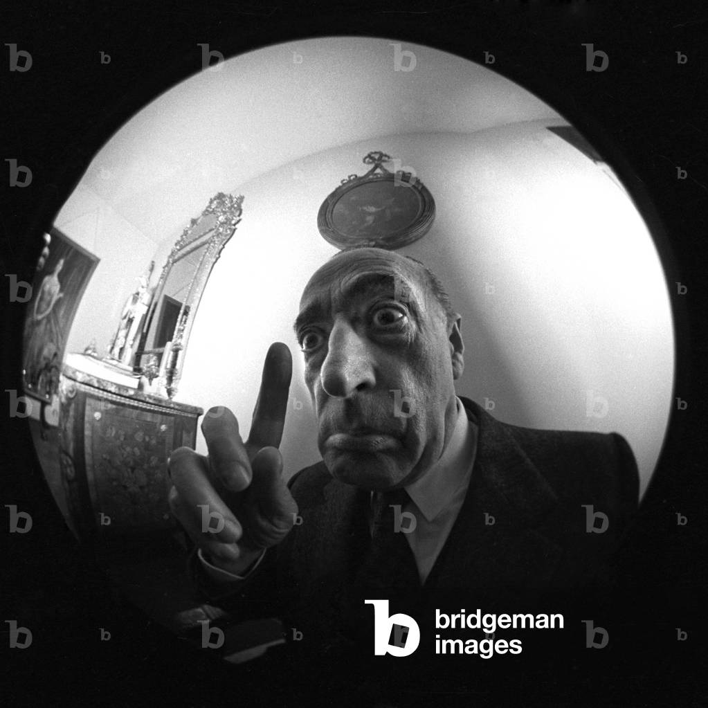Toto making a face in front of a distorting lens, Rome, 1967 (b/w photo)
